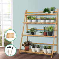 Bamboo plant stand with pots and plants
