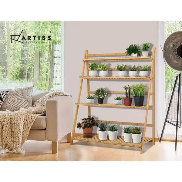 Bamboo plant stand with wooden shelf holding plants