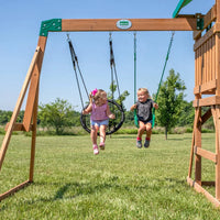 Girl having fun swinging on backyard discovery grayson peak play centre