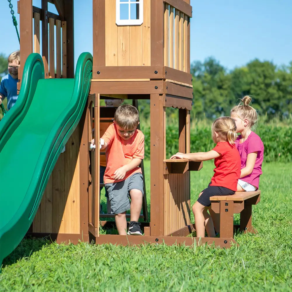 Kids playing on backyard discovery lakewood play centre with raised fort and real door, featuring two belt swings