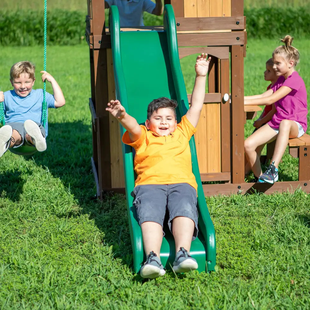 Children playing on a swing set at backyard discovery lakewood play centre