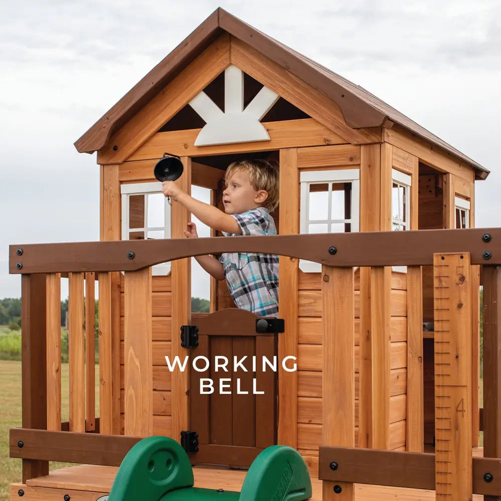 Backyard discovery wooden echo heights cubby house with slide: young boy playing in playhouse