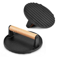 Cast iron grill press with wooden handle on white background