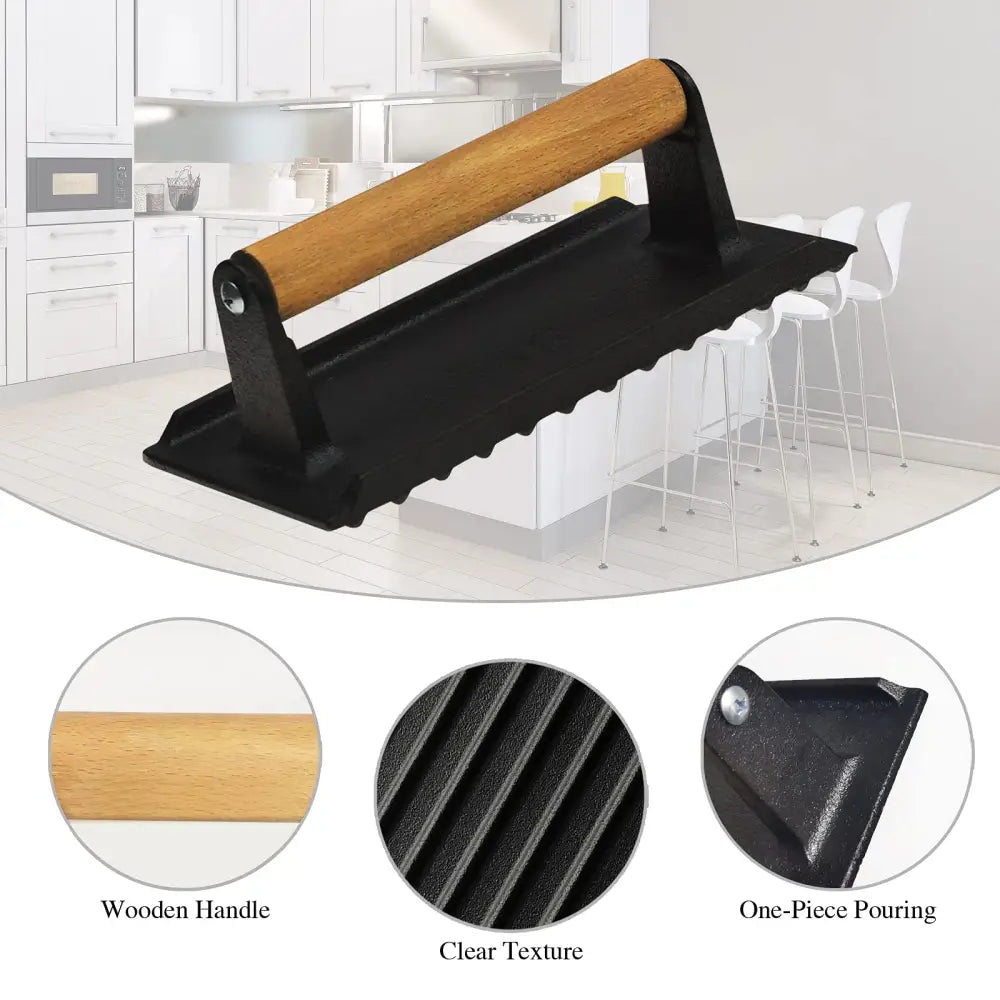 Cast iron grill burger press with wooden handle on black and white kitchen mat