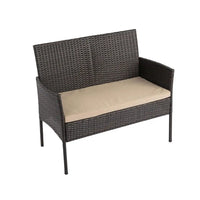 Four piece outdoor lounge set: black wicker chair with tan cushion