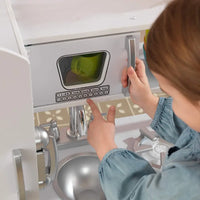 Young chef placing microwave in doll cottage kitchen (model 3) play kitchen