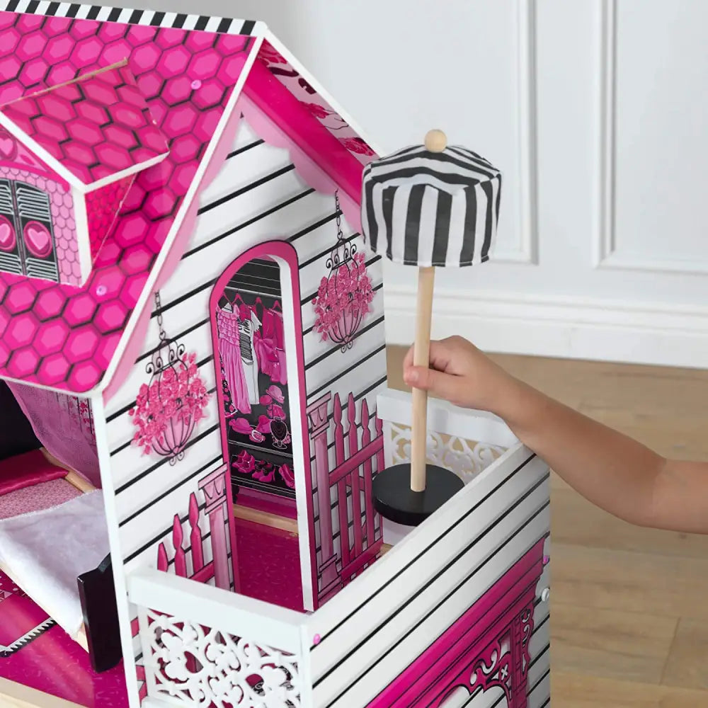 Girl happily playing with her four feet tall dollhouse with furniture, including 15-piece accessory set