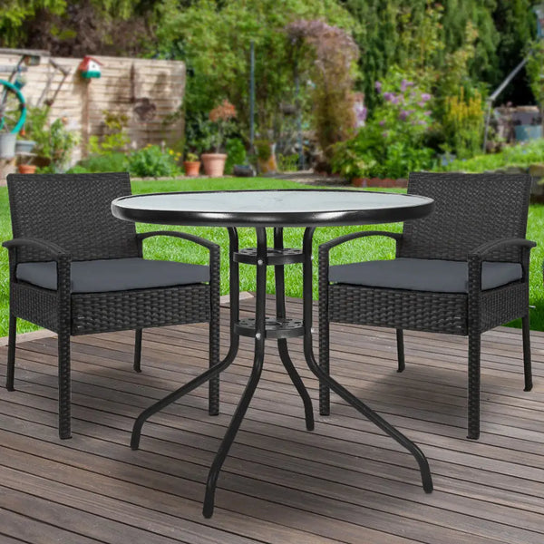 Outdoor bistro set with black patio table and chairs on wooden deck