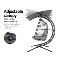 Resin wicker bird cage with bird on gardeon swing chair with adjustable canopy