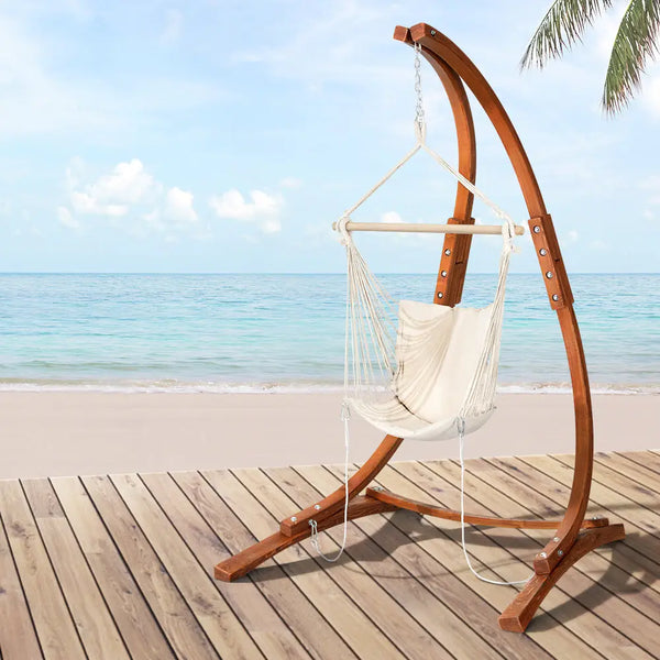 Gardeon timber hammock chair swaying gently on the beach