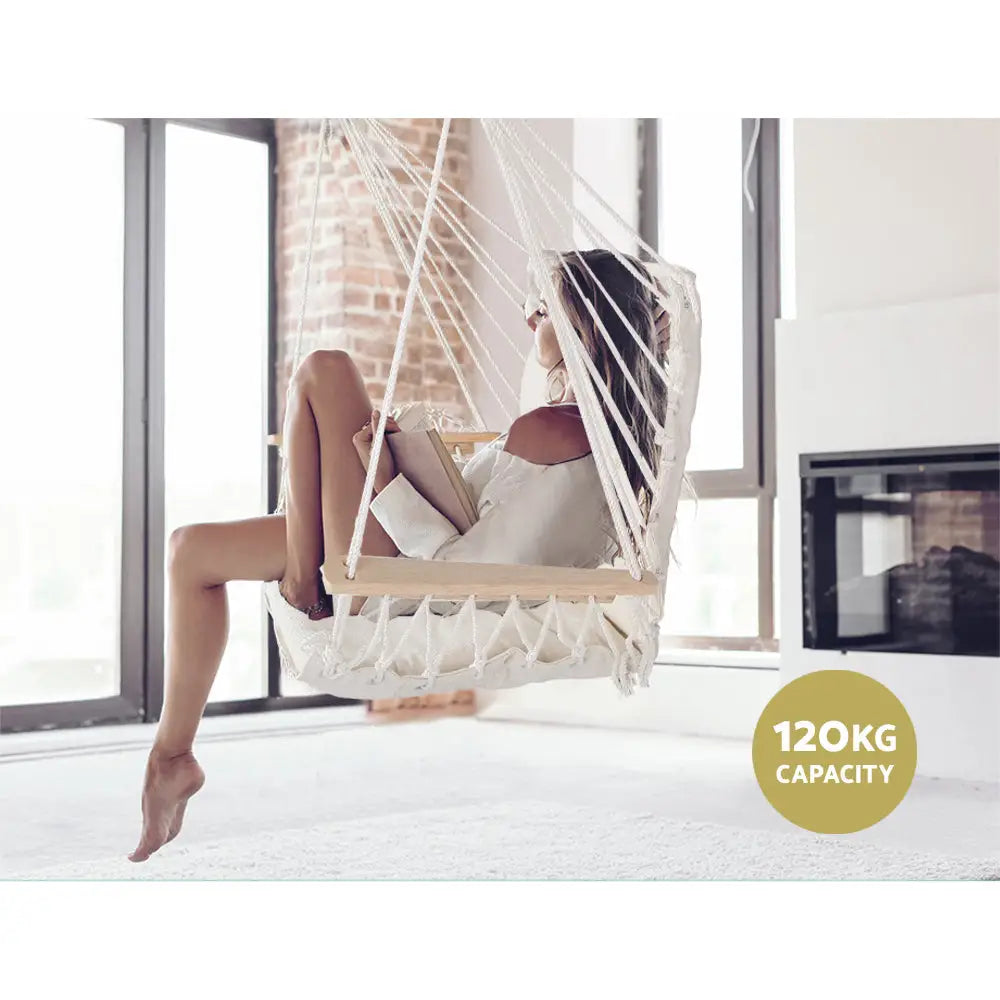 Woman sitting in gardeon hanging hammock chair with armrests, reading book - quality polyester cotton for long-lasting comfort