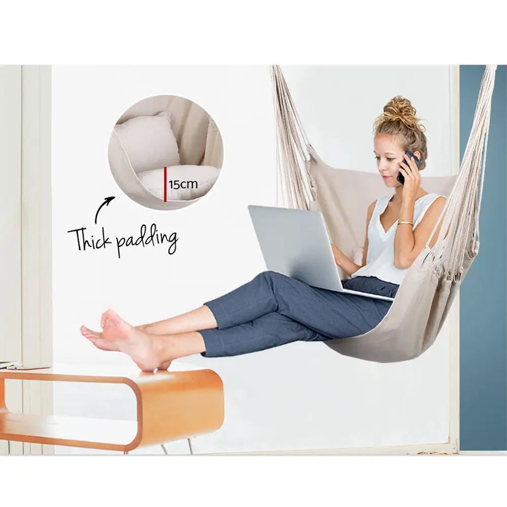 Woman sitting on gardeon hanging hammock chair with cushion using laptop - polyester cotton fabric, timber rail trim
