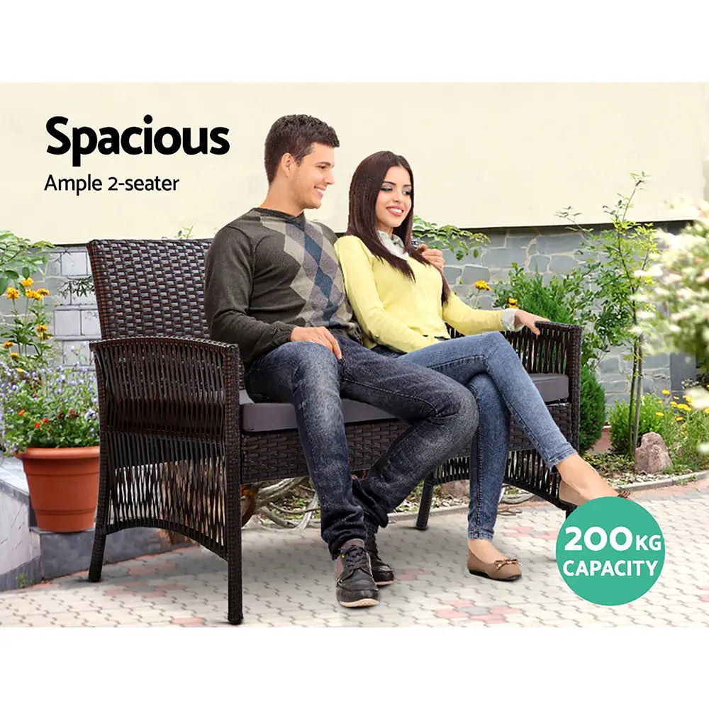 Gardeon harp 4pcs outdoor lounge sofa set with man and woman sitting on wicker bench in garden