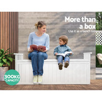 Woman and child sitting on outdoor storage bench reading a book