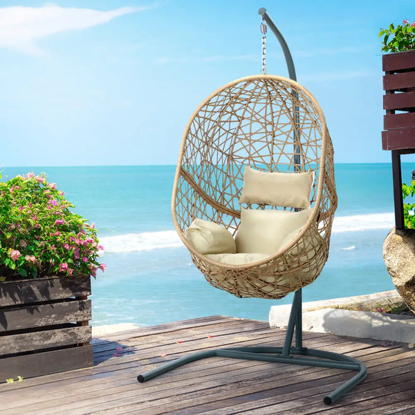 Gardeon wicker egg swing chair on wooden deck with ocean view