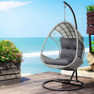 Gardeon wicker egg swing chair with steel stand overlooking ocean