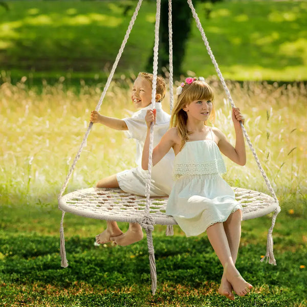 Two kids enjoying a swing in a field, gardeon woven hanging swing seat 100cm - cream