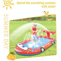 Young boy playing in inflatable sprinkler pool with water gun
