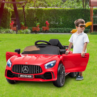Little boy enjoying ride in red mercedes amg gtr electric car