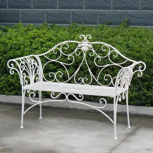 Katerina iron bench seat - white in front of bush