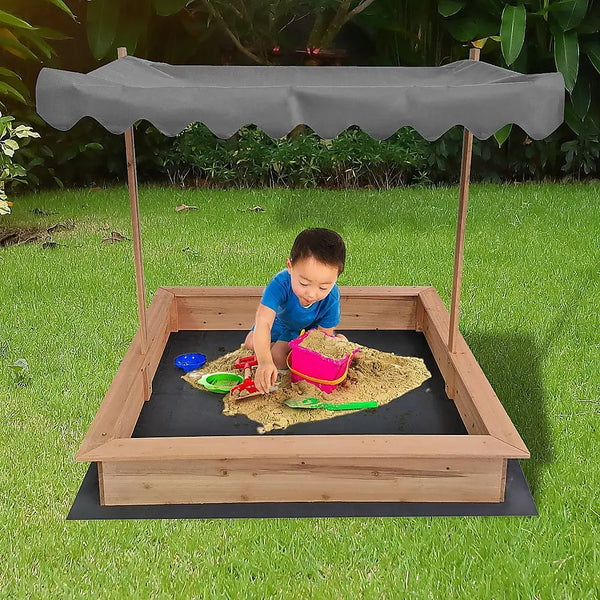 Child playing in sandbox with adjustable canopy kids wooden toy sandpit, protecting from harsh uv rays