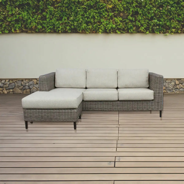 Lara 3 seater outdoor sofa rattan reversible chaise - light grey on wooden deck with green wall