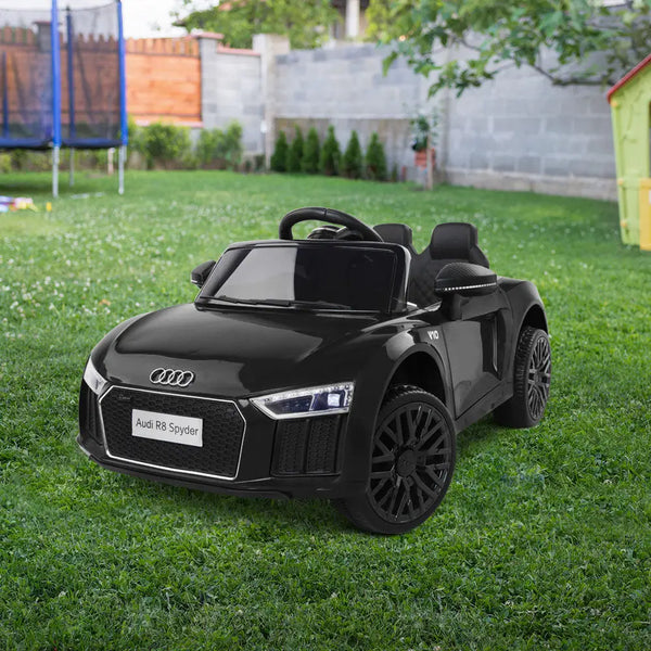 Black audi r8 ride on electric car on grassy field