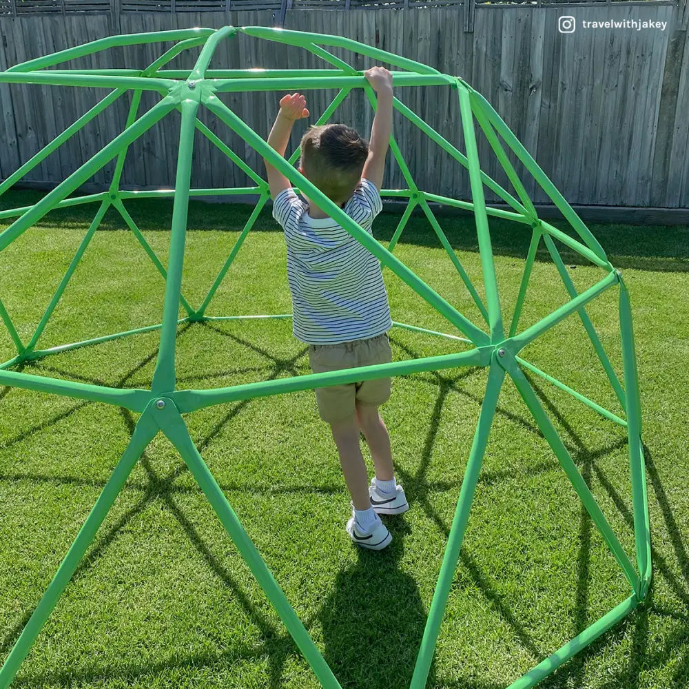 Child playing with rust resistant powder coated, green plastic ball on lifespan kids 2.5m dome climber 2.5