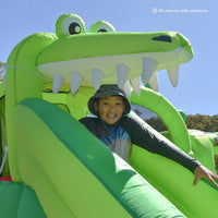 Woman happily slides down giant inflatable at lifespan kids crocadoo slide & splash