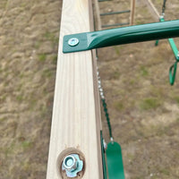 Green handle on wooden rail of lifespan kids daintree 2-in-1 monkey bars & swing set