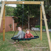 Two boys playing on spidey web swing frame
