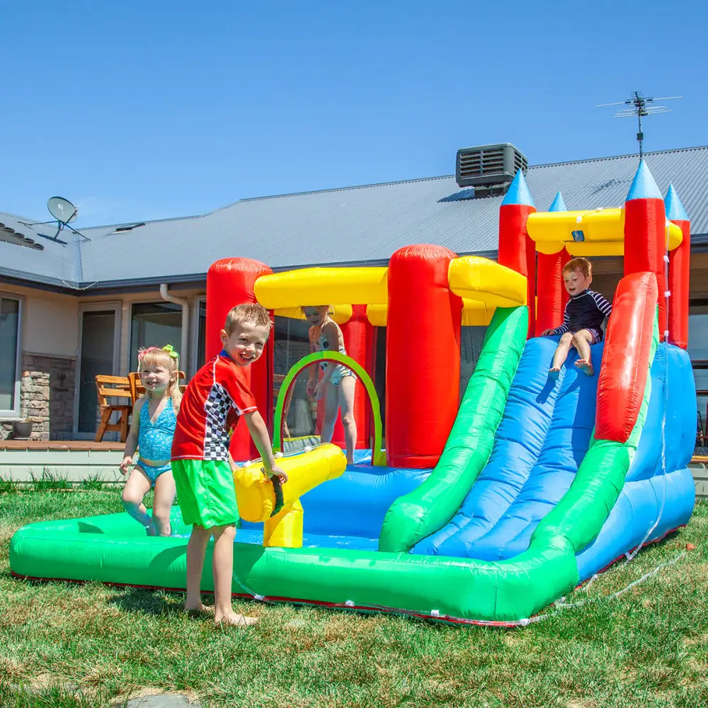 Two children playing in an inflatable with electric air pump by lifespan kids surrey 2 slide & splash