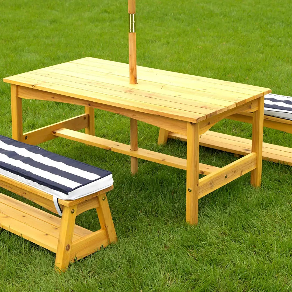 Outdoor navy kids table & bench set with cushions & umbrella on grass