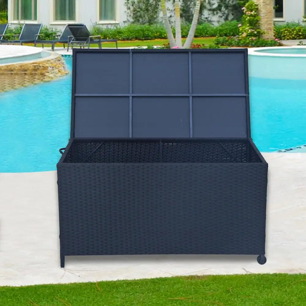 Black wicker storage box with pool in background, perfect for outdoor items year-round