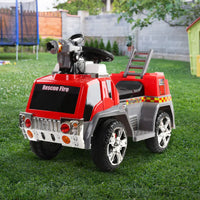 Red and gray toy car on grass: rigo kids electric ride on fire engine fighting truck toy cars 6v