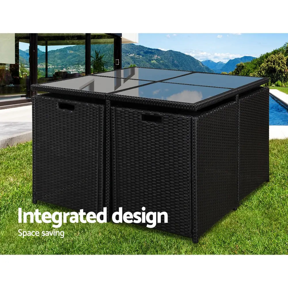 Black wicker storage box with glass top on grass, rio garden 5pc outdoor dining set - powder coated steel frame, water-resistant covers