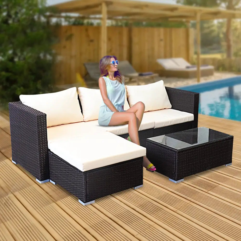 Woman relaxing on patio chair next to pool in sarantino 5pc modular outdoor lounge set rattan - brown