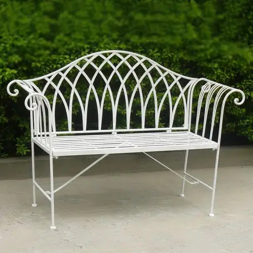 Antique white lavinia iron outdoor bench on cement floor